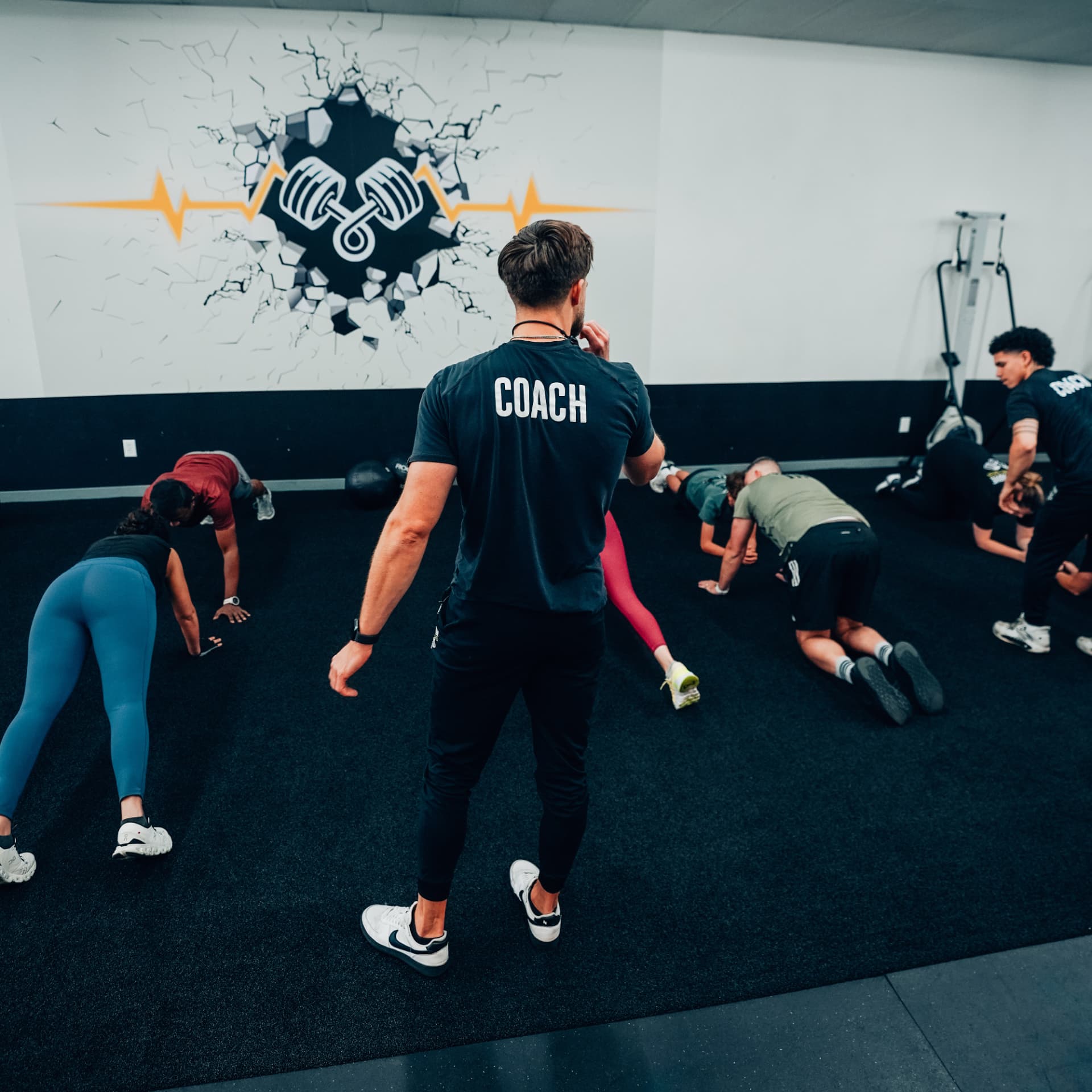 Coach leading an adult group strength session at On The Move Fitness in Clifton Park, New York